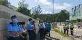 A number of police officers are seen guarding outside the Apple Daily building