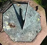 Sundial on top of the former spire finial