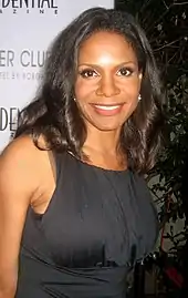 Audra McDonald in a black dress against a white background