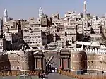 Walled city with traditional mudbrick houses decorated with white details