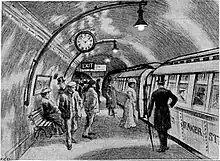 Sketch showing about a dozen people standing on an underground railway platform with a train standing at the platform. Several more people are visible inside the train, which has the words "Baker St" visible on its side.