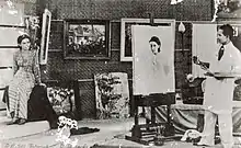 A man painting a woman