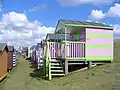 Colourful rows of wooden huts on the grassy slopes of "Tankerton slopes" below Marine Parade