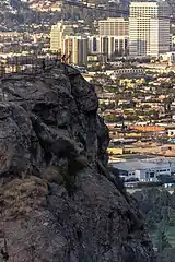 Hikers climb the summit of Bee Rock in Griffith Park, Los Angeles.