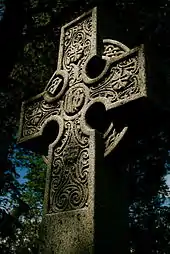 A stone Celtic cross in Beechwood Cemetery