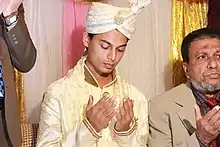 Groom is praying according to Muslim marriage rituals