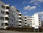 A long four-storey apartment building in Modernist style