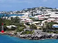 Residential suburb near the old St. George's Garrison, with "Town Cut Battery" or "Gate's Fort" on the shore of the Town Cut, and St. George's Town and harbour in the background