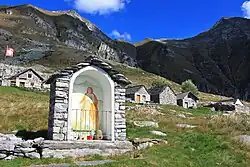 Image 21An "Alp" refers to a high elevation pasture frequented only in summer. It often includes several huts and small places of worship (here the Alpe Bardughè in Ticino). (from Alps)