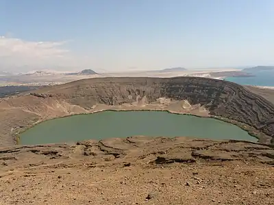 A crater filled with water in a desert