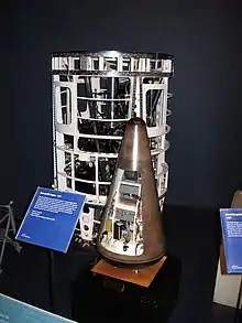 A rocket engine section with a re-entry vehicle beside it.