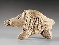 A clay boar figurine from the Neolithic period, found at Tepe Sarab, kept at the Museum of Ancient Iran.