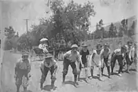 First Congregational Church of Sierra Madre Sunday foot race of Church boys in 1890 on Central Ave (Sierra Madre Blvd). Looking west, the camera is in front of the Old North Church.