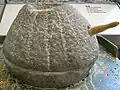 Interactive quern-stone display.