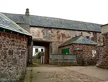 Gatehouse and barn abutting west end at Bratton Court