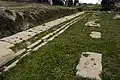 The series of slotted bases in the building north of the stoa