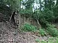 A large brick retaining wall behind the site of the blast furnaces.