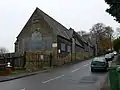 The large gate at foreground left was until the 1980s the site of the level crossing at Brymbo West, where the line crossed Brymbo High Street.