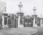 Forecourt gate piers, gates, railings and lamps