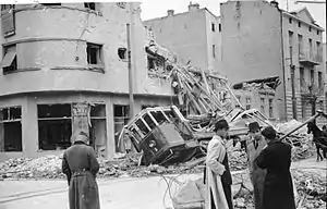 a damaged building and damaged tram