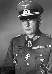 A man wearing a military uniform with an Iron Cross displayed at the front of his uniform collar.