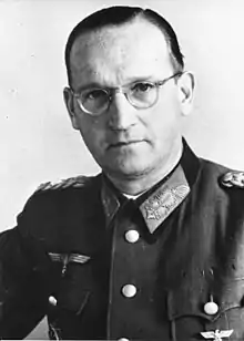 a man in semi profile wearing a military uniform and glasses.