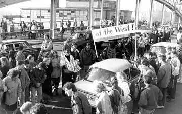 Students from West Berlin encouraging East Berliners as they cross the border the day after the fall of the Berlin Wall.