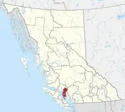 A map of British Columbia depicting its 29 regional districts and equivalent municipalities. One is highlighted in red.