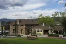 A two-story stone building and parking spaces