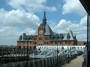 Communipaw Terminal, a historic building, with the dock in foreground provides  ferry transport to Ellis Island and Statue of Liberty