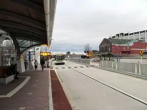 A bus approaching a bus station in an urban area