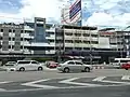 Brutalist shophouses beside a contemporary office block in Chatuchak District, Bangkok.