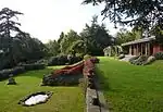 Capel Manor House, including the remains of the winter garden and the arcaded retaining wall with balustrade and steps belonging to an earlier house