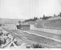 Cascade Locks, circa 1897, looking south, showing middle lock and lockmaster and engineer buildings on embankment on south side