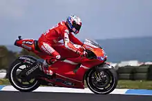 Casey Stoner, riding his 2010 Ducati Desmosedici GP10 in Philip Island, Australia. Note that the alternative "barcode" livery has been removed completely.