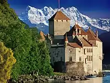 Image 6Château de Chillon, a castle on the north shore of Lake Geneva, against the backdrop of the Dents du Midi (from Alps)