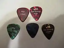 Assorted tortoiseshell celluloid guitar picks.