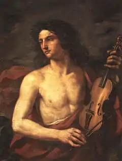 A young man with long flowing hair, bare chested, holds a stringed instrument in his left hand, while looking way to the left with a soulful expression