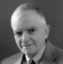 tight headshot of an older white man with short white hair