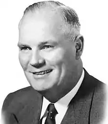 Black and white photo of a middle-aged man in a suit and tie