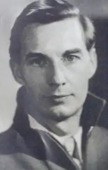 Frank O'Connor in his twenties. He is a caucasian man with short, well-groomed hair. He wears what appears to be a collared shirt, likely button-up, possibly with a necktie, underneath a jacket with a popped up collar.