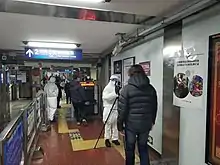 Subway staff in protective clothing check the temperature of a passenger with thermographic camera on January 27, 2020.