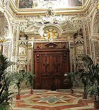 Main entrance surrounded by marble carvings.