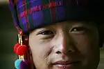 Chinese man in traditional hat of silk tartan with wool pompons, 2008