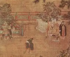 A painting of a play being staged in a courtyard. In the center, a man in loose black robes appears in mid-bow or mid-dance. To the left, two men dressed as guards are holding a third man, dressed in the same attire as the man in the center. To the right, a heavy set man sits in a throne. Behind him stand three women in white face paint and a man dressed in the same attire as the man in the center.