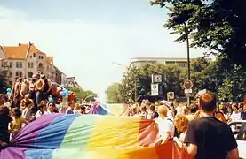 Marchers carry the LGBT pride flag at the pride parade on Christopher Street Day, Berlin, Germany (1997)