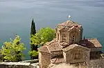 Stone church next to a lake.