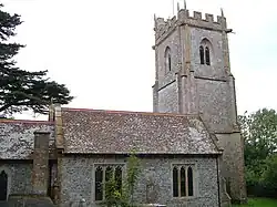 Stone building with square tower.