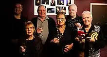 with drinks in their hands the members of Circa Council pose for a photo in the foyer