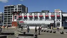 Circa Theatre building view from the waterfront showing people walking in the foreground